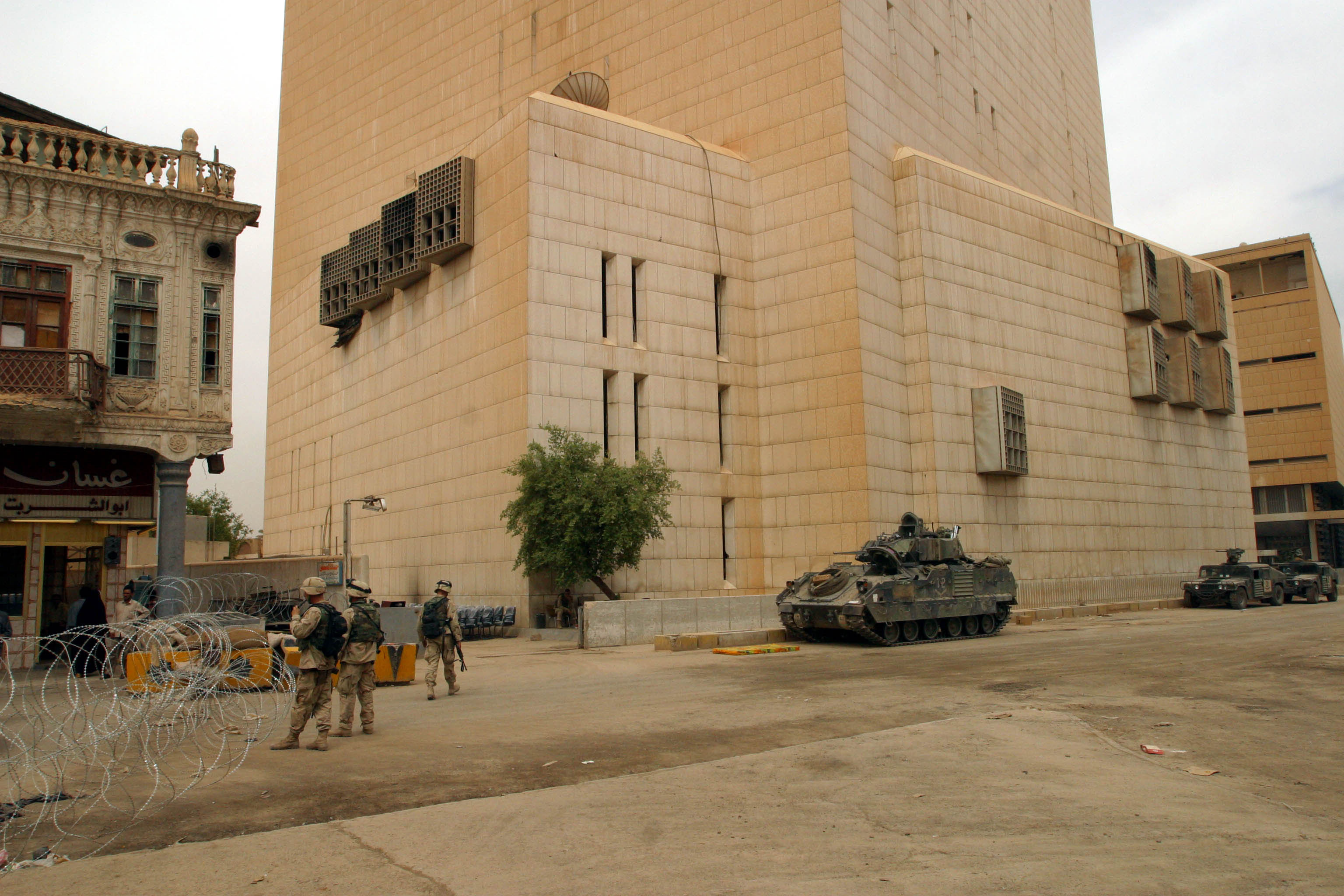 US troops guard the Central Bank of Iraq. The building was looted during the war. USAIDS is providing a "ministry in a box" which includes desks, chairs, telephones and computers to help get the misintry get back to business.